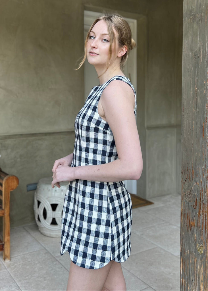 scalloped hem gingham dress navy and cream checkered pattern tablecloth dress with pockets round neckline sleeveless mini dress cocktail country club outfit chic