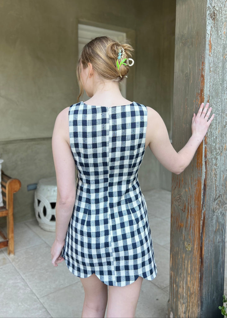 scalloped hem gingham dress navy and cream checkered pattern tablecloth dress with pockets round neckline sleeveless mini dress cocktail country club outfit chic